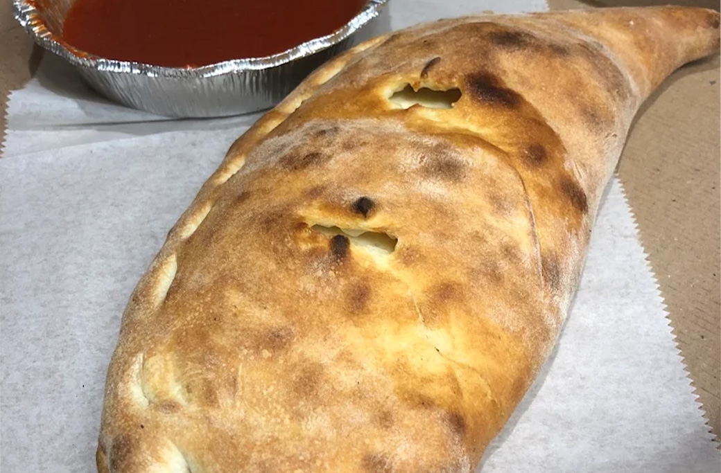 Ham and cheese calzone made with traditional pizza dough at Fusaro’s Pizza & Pasta