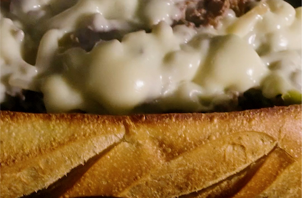Cooper Sharp white American cheese melting into chopped cheesesteak at Fusaro's